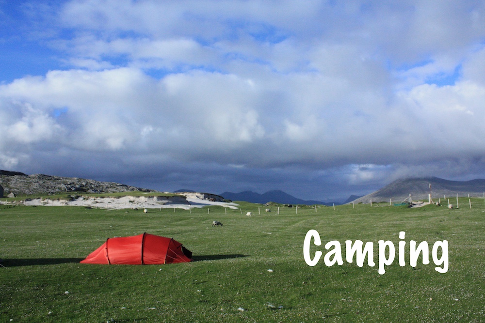 Red tent pitched behind a beach